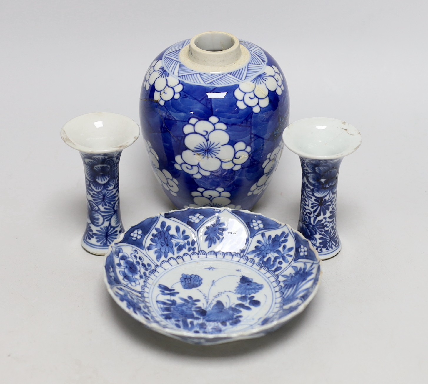 A Chinese blue and white prunus jar, two miniature vases and a dish, all Kangxi period, jar 14cms high